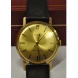A gentleman's 9ct gold Tudor wristwatch, the champagne dial with gilt hands and batons, on