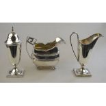 A George III silver milk jug with gadrooned rim and angular scroll handle,