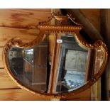 A Regency style plaster giltwood mirror surmounted by an urn,