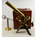 A Victorian brass microscope with magnifying glass, in mahogany box,