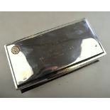 An Edwardian silver cigarette box, mounted with a gilt Japanese floral roundel and fitted with a