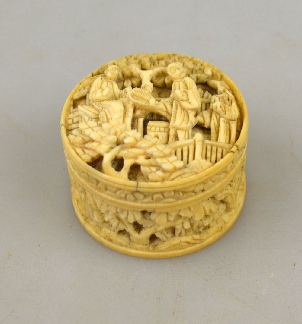 A Chinese Canton ivory pill box, 19th century, carved with figures on a terrace with pine trees, 3.