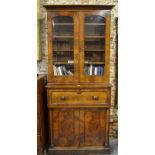 A 19th century flame mahogany secretaire bookcase, having a pair of arched glazed panel doors
