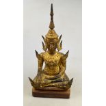 An 18th / 19th century Burmese gilt bronze Buddha seated in dyanasana, heavily patinated, raised