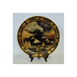 A Chinese black lacquer circular tray decorated in gilt with figures swimming amongst lotus in a