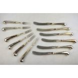 A set of six late Victorian dessert knives and forks with silver blades and loaded silver