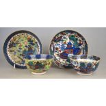 Two Chinese 18th century clobbered large tea bowls and saucers, both decorated with pagodas in a