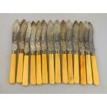 A set of fourteen Victorian fish knives with foliate engraved silver blades and ivory handles (a/f),