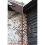 A rare 18th century cast iron and scroll work steeple weather vane with revolving flag direction