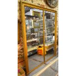 A large Victorian gilt framed two panel wall mirror, the plates divided by a vertical,