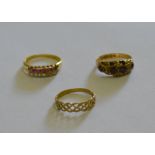 A ruby and diamond ring set with seven rose diamonds and seven small rubies in two rows, yellow