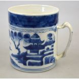 A Chinese blue and white mug decorated with a watery landscape having a double twisted strap handle,