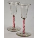 A pair of Georgian style cordial glasses, having elongated campana bowls and multi red and opaque