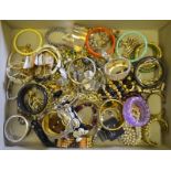 A quantity of bracelets and bangles including gilt metal, diamante, mother-of-pearl,