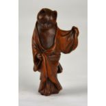 A Japanese wood netsuke carved in the form of a robed cat, 20th century, 5.5 cm high Condition