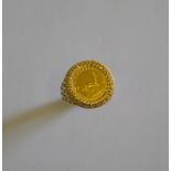 A 1/10th Krugerand coin, 1985, in 9ct yellow gold lattice style ring mount,