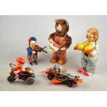 Three Japanese clockwork toys:- Clown with maracas, bear with nursery book,