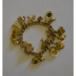 A 9ct yellow gold curb bracelet having engraved padlock and nineteen various charms attached,