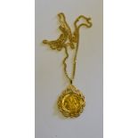 A 1979 sovereign in ornate cast pendant setting on 9ct yellow gold curb style chain,