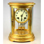 A French oval four-glass mantle clock with enamel dial,