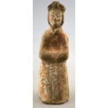 Chinese 5th century AD - a pottery funerary figure of a standing court lady, her arms folded,