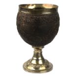 A George IV coconut cup with silver collar and stemmed foot,