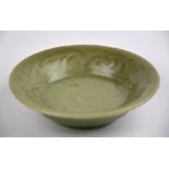 Chinese early Ming Dynasty - a Longquan celadon small dish carved with flowers and foliage, c.