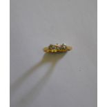 A three-stone diamond ring, yellow and white metal set, stamped 18ct and plat, approx. 0.50 carat in