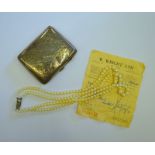 A double row graduated cultured pearl necklace on gilt metal snap c/w original receipt dated 1968,