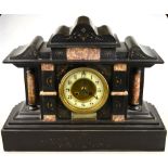 A late 19th century slate and marble architectural form eight-day mantel clock having an