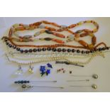 A collection of various jewellery items including a row of black and white agate beads,