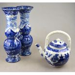 A Royal Worcester teapot having blue and white willow pattern transfer decoration, date cypher