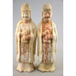 Chinese Tang Dynasty 618 - 907 AD - a pair of pottery funerary figures with traces of cold