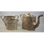 An Indian heavy quality white metal three-piece ovoid tea service, ornately embossed and chased with