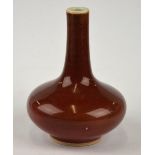 A Chinese 19th century small ovoid vase with cylindrical neck, glazed overall with copper red glaze,