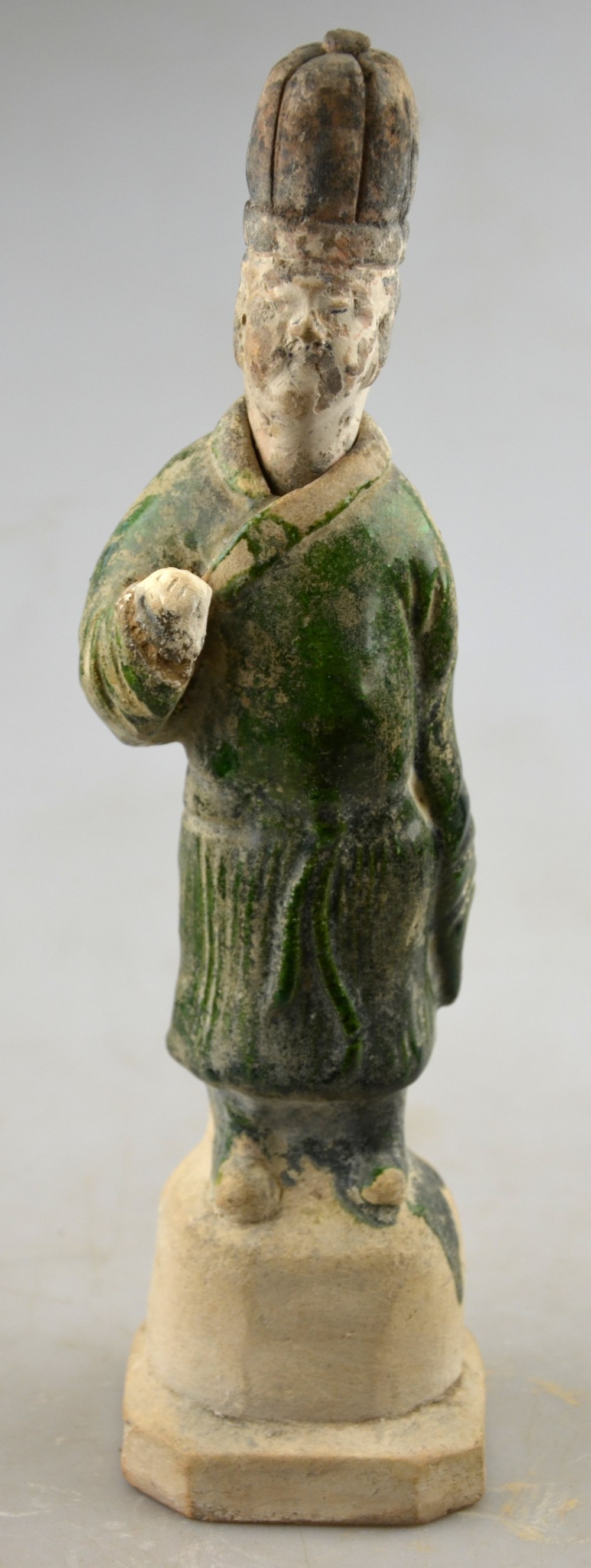 Chinese 10th century AD - a pottery funerary figure of a man wearing a green glazed robe,