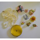 A collection of porcelain brooches including Crown Derby,