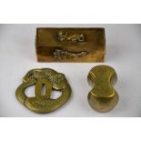 A Japanese 19th century brass tsuba in the shape of a coiled snake, three character mark, 7.8 x 7.