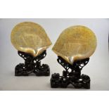 A pair of 19th century Chinese Canton mother of pearl shells, one carved with figures on a boat on a