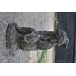 An old weathered garden / water feature statue of putti with dolphin,