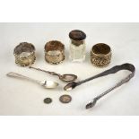 A pair of Victorian king's pattern sugar tongs, London 1852, to/w three silver napkin rings,