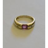 An oval pink tourmaline ring having small diamonds on either side,