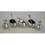 A silver five-piece condiment set with blue glass liners, on ball feet, Stokes & Ireland Ltd.