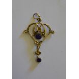 An Art Nouveau gold pendant set with amethyst and seed pearl stamped 9ct Condition Report One