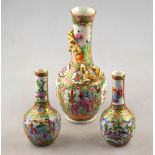 A Chinese 19th century Canton famille rose ovoid vase with long neck moulded with gilded dragons,