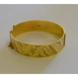 A 9ct hinged and facetted bangle,