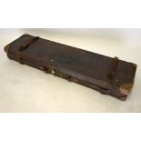 An antique leather gun case, trade label to interior for W W Greener,