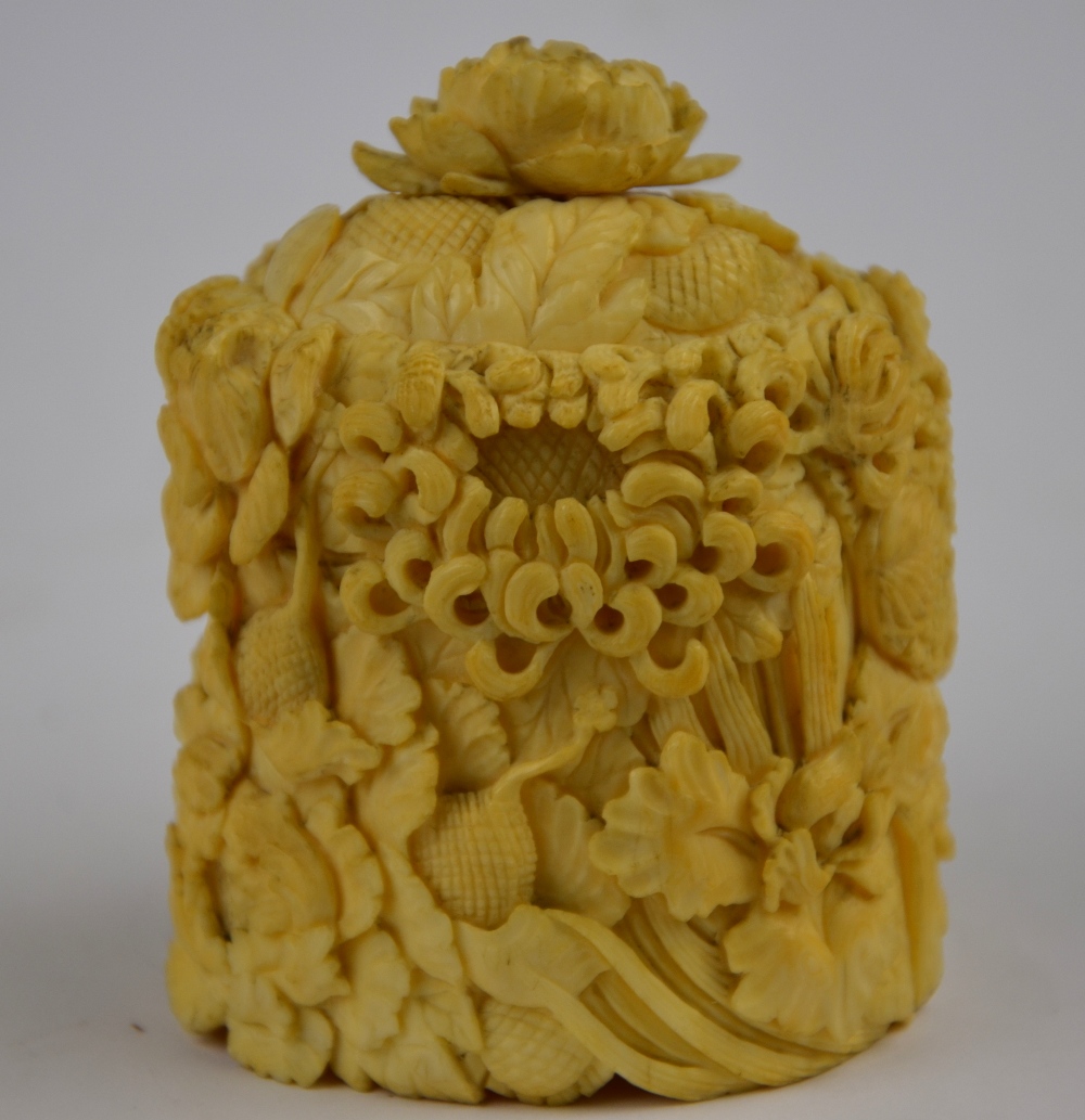 A 19th century Chinese Canton ivory oval pot and cover carved with chrysanthemums and other flowers,