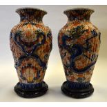 Japanese Meiji Period - a pair of large fluted Imari vases moulded with dragons contesting flaming