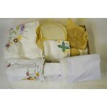 A collection of assorted table linen to include embroidered tablecloths,